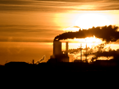 Smoke stacks in Saskatchewan, Canada, symbolize the ongoing challenges of climate change and environmental impact, highlighting the region's need for sustainable energy policies.
